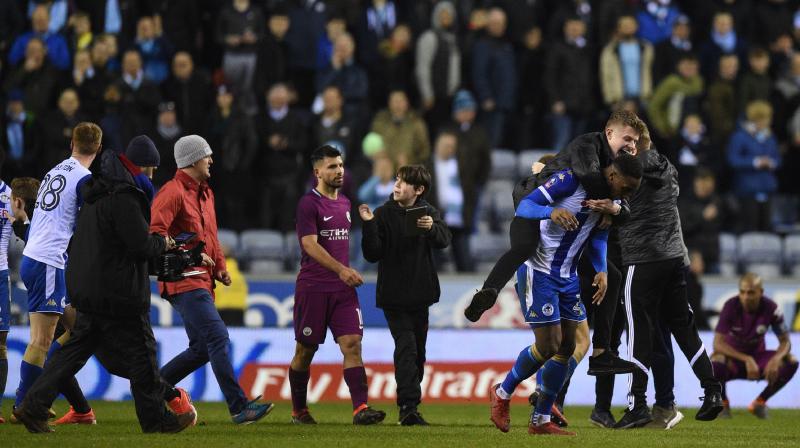 Wigan earlier on Tuesday announced a full investigation into the crowd disturbances that marred the clubs dramatic victory which came courtesy of a 79th-minute strike from Will Grigg, ending Citys quest for a historic quadruple. (Photo: AFP)