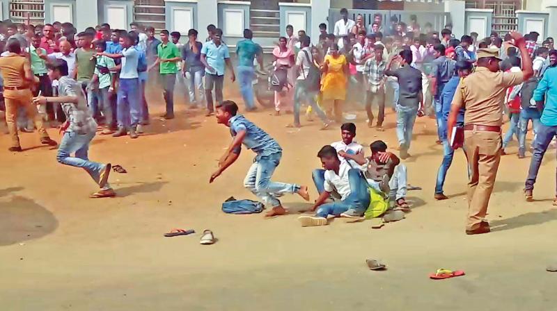 Police resort to mild lathi-charge to disperse students of a government-aided college in Tiruparankundram near Madurai for protesting against bus fare hike on Tuesday (Photo: DC)