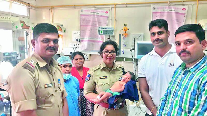 Police officials with the seven-day-old baby of Vijaya and Mari Sabawat who was kidnapped on Monday from Koti Maternity hospital and was traced by the police in less than 24 hours.