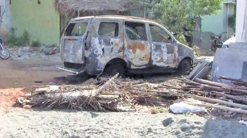 The charred car after petrol bomb was hurled on it (Photo: DC)
