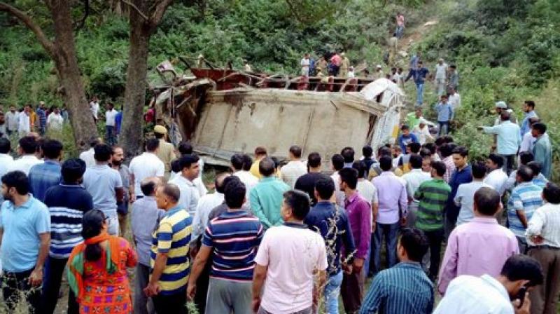 Locals carry out rescue operation after a bus rolled in deep gorge at Reasi in J&K (Photo: PTI)