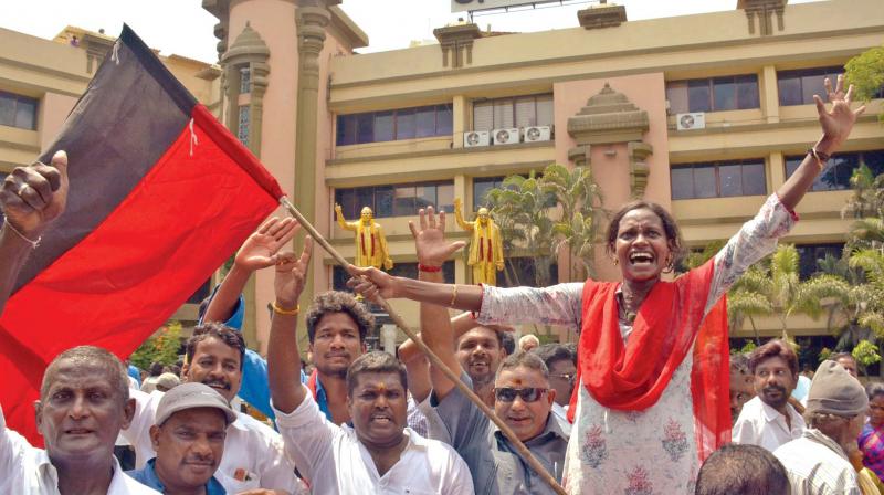Cadres wave the DMK flag and celebrate at the Anna Arivalayam on Thursday. 	 DC