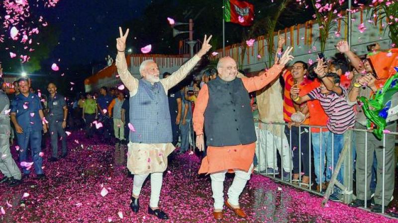 Bharatiya Janata Party workers welcome Prime Minister Narendra Modi as he, along with BJP president Amit Shah, arrives at the party headquarters to celebrate the partys victory in the Lok Sabha elections in New Delhi (Photo: AP)