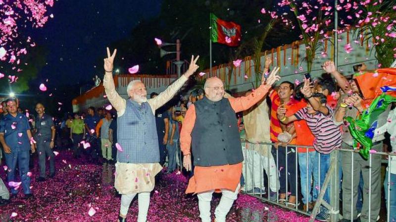 Bharatiya Janata Party workers welcome Prime Minister Narendra Modi as he, along with BJP president Amit Shah, arrives at the party headquarters to celebrate the partys victory in the Lok Sabha elections in New Delhi (Photo: AP)