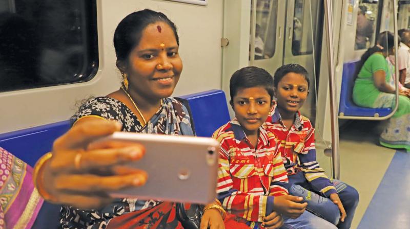 Woman takes selfie with her sons as they avail the free ride on Chennai metro. (Photo: DC)