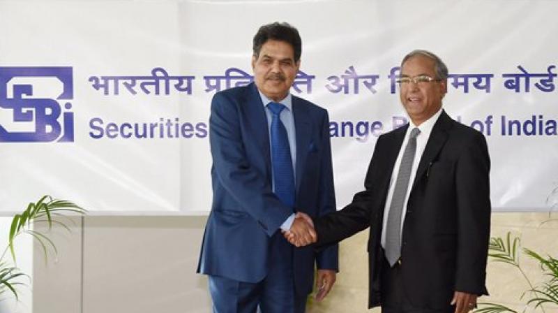Newly appointed SEBI Chairman, Ajay Tyagi is greeted by the outgoing chairman, U K Sinha as he assumes charge at the SEBI headquarters in Mumbai. (Photo: PTI)