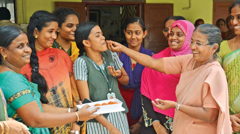 A Sister at the Little flower convent for special children shares her joy by greeting the students with sweets. (Photo: DC)