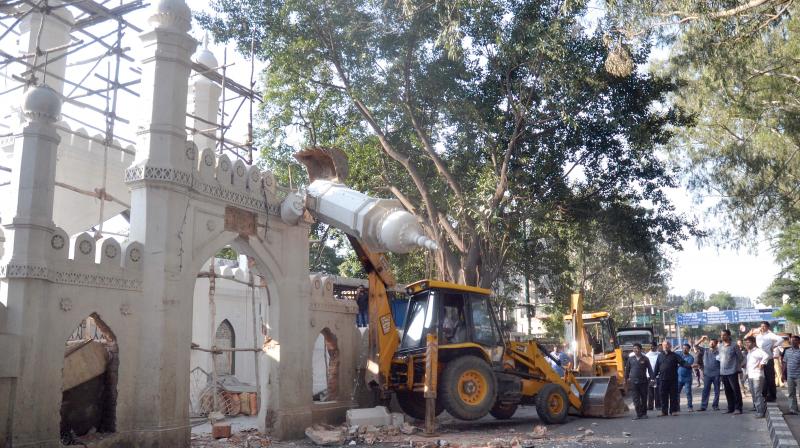 Wall of the Shia mosque, near Johnson Market being demolished with the cooperation of the managing committee of the mosque for the widening of Hosur Road, in Bengaluru on Sunday 	 Shashidhar B.