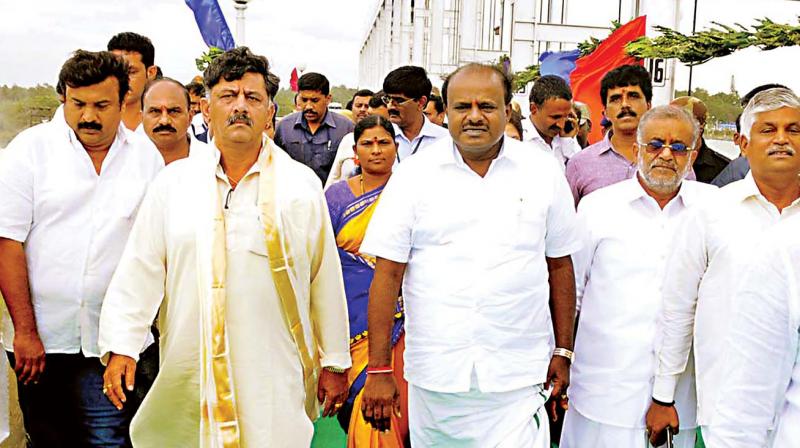 Chief Minister H.D. Kumaraswamy and ministers D.K. Shivakumar and G.T. Deve Gowda at KRS reservoir near Mandya on Friday to offer Baagina to Cauvery 	(Photo:  KPN)