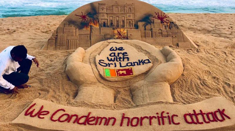 Sand artist Sudarshan expresses through his work on the Puri beach in Odisha his grief for the horrific attacks in Sri Lanka and pledges  solidarity with the traumatised island nation. 	(Courtesy: BBC)
