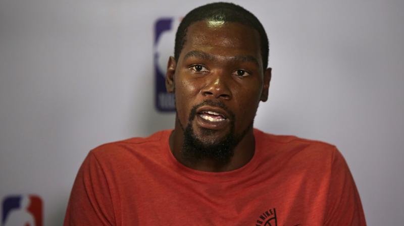 \Mud in the middle of the street, houses were not finished but there were people living in them. No doors. No windows... stray dogs and then, boom, Taj Mahal, one of the seven wonders of the world,\ Kevin Durant said about the trip in an interview with The Athletic website published this week. (Photo: AP)