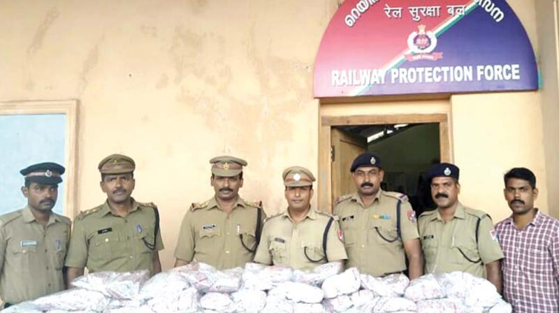 The officials of excise enforcement and  anti-narcotic special squad and railway protection force with the seized tobacco products in Kozhikode on Monday