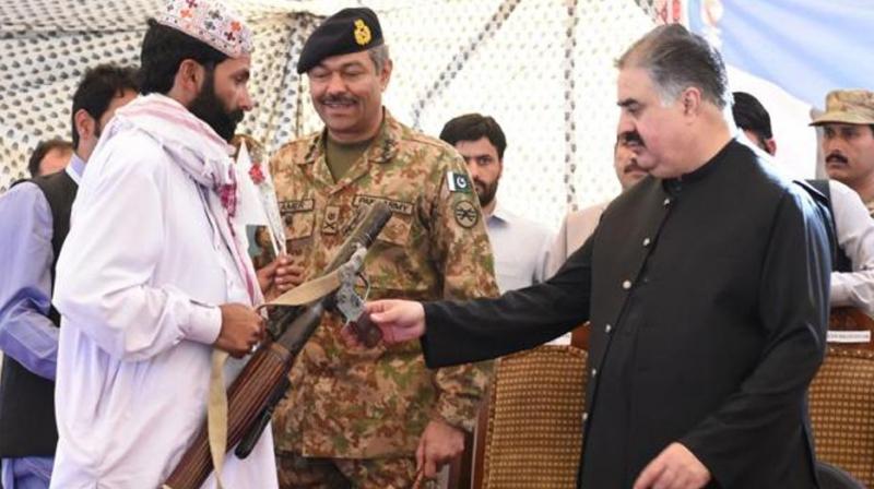 A Baloch militant hands over his weapon and surrenders to Baluchistan province Chief Minister Sardar Sanaullah Khan Zehri in Quetta on April 21, 2017. (Photo:AFP)