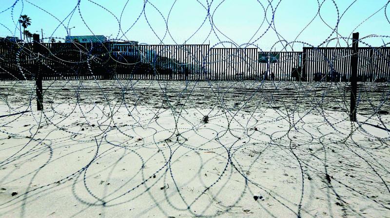 Barb wire is seen at the US-Mexico border wall at Friendship park in San Ysidro, California on Sunday. Thousands of migrants faced the bleak reality that their American dream was about as untouchable as it was when they started.  	(Photo: AFP)