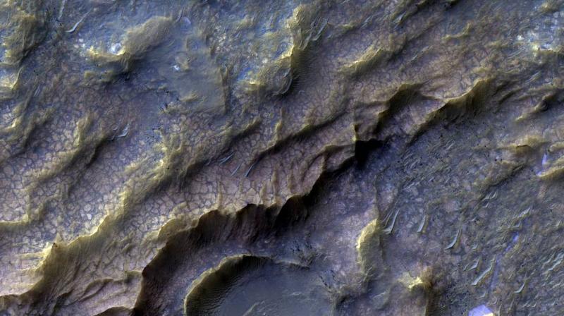 Water may have flowed on ancient Mars in peak summers, even though the red planet was generally frozen over, a study suggests.
