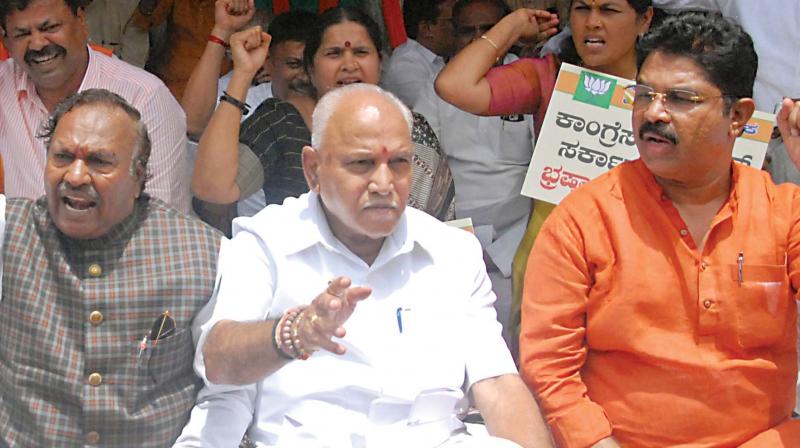 BJP leaders K.S. Eshwarappa, B.S. Yeddyurappa and R. Ashok protest in Bengaluru on Friday against the sale of land to the Jindal group at a throwaway price in Ballari