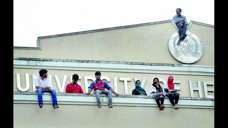 Students of Fathima Medical College from Kadapa threaten to jump down the NTR Univeristy of Health Sciences building in Vijayawada on Wednesday. (Photo: DC)