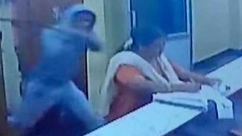 The video of the incident shows a man attacking the woman, Kumari, administrator of Kotilingeshwari temple in Kolar with a machete. (Photo: Videograb)