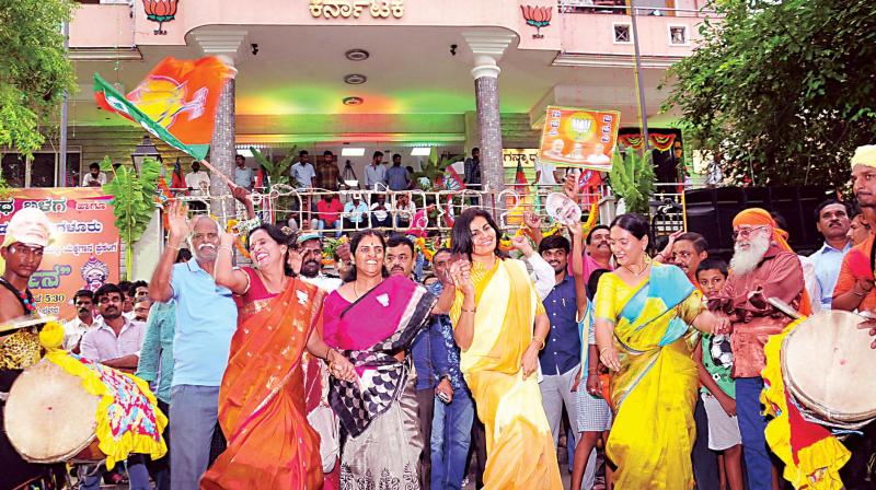 BJP workers celebrate swearing in of PM Narendra Modi and his cabinet members, in Bengaluru on Thursday (Photo: DC)