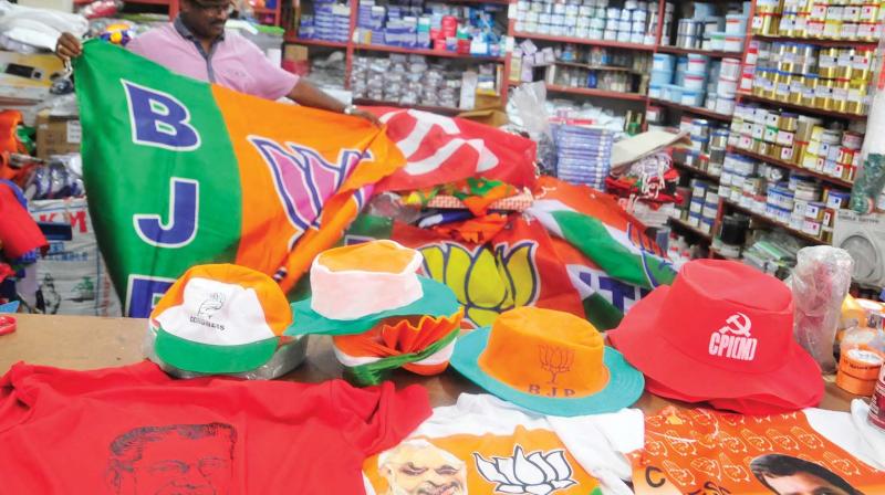 A shopkeeper keeps accessories of various political parties ready with Lok Sabha elections around the corner (Photo: DC)
