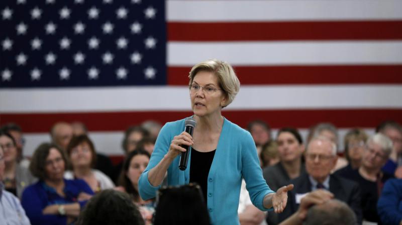 He would be \in handcuffs\ if not President: Democrat Warren swipes at Trump