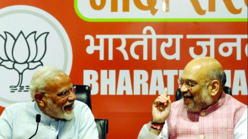 Prime Minister Narendra Modi with BJP president Amit Shah during a press conference at the party headquarters in New Delhi on Friday. (Photo: Pritam Bandyopadhyay)