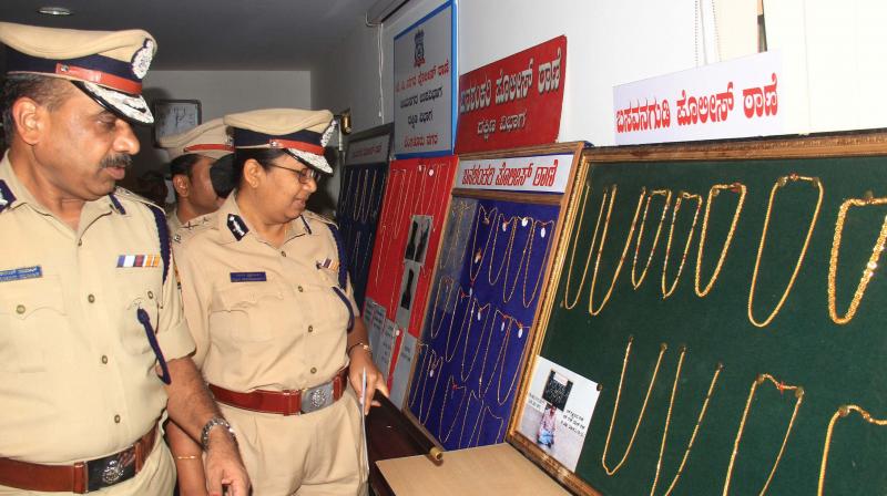 Police Commissioner T Suneel Kumar with Additional Commissioner Malini Krishnamoorthy inspecting the valuables recovered from Irani Gang during a press conference in Bengaluru on Friday