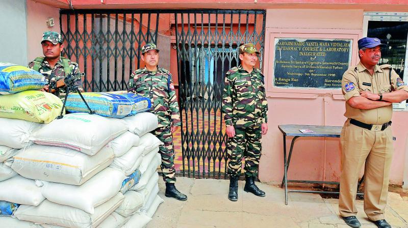 Security personnel guard the counting centre at Kamala Nehru Exhibition Grounds in Yakutpura Assembly constituency on Saturday. 	 DC