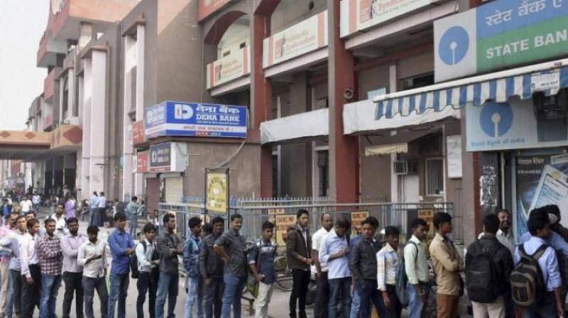 Uma Shankar, a resident of Durga colony in Goverdhan, was queued outside the Govardhan branch of Central bank on Friday, to withdraw money for the treatment of his ailing son. (Photo: Representational Image/PTI)