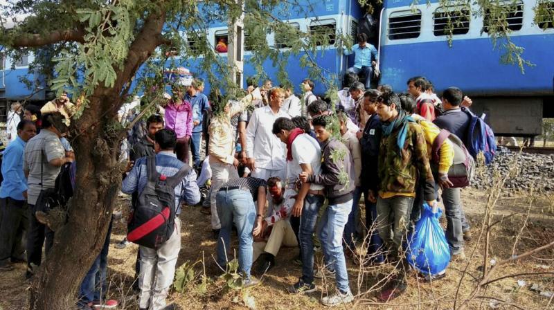 People attend to an injured person after a blast in the Bhopal-Ujjain passenger train near Jabdi station in Shajapur district in Madhya Pradesh. (Photo: PTI)