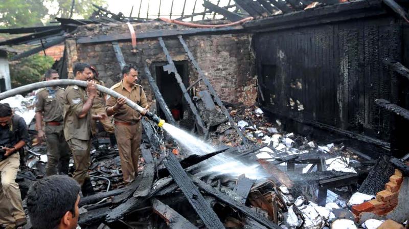 Fire personnel put out the fire that broke out at a post office near the Sree Padmanabhaswamy temple, in Thiruvananthapuram, on Sunday morning.(Photo: DC)