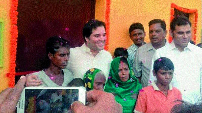 Varun Gandhi with the marginalised farmers at their new pucca houses 	(Photo: DC)