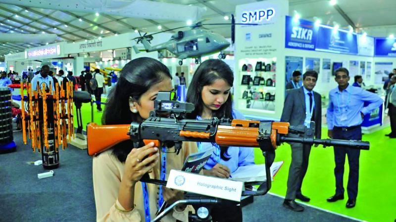 Participants check a rifle at DefExpo 2018 at Thiruvidanthai on Wednesday. (Photo: DC)