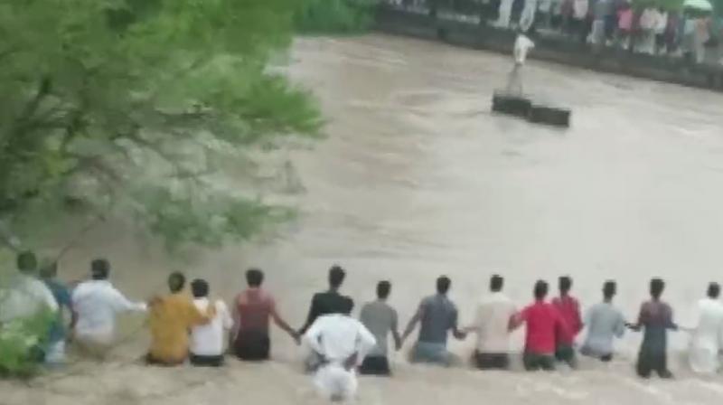 MP: Human chain to rescue 2 people washed away in an overflowing stream