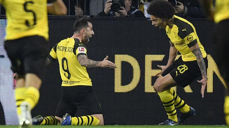 Robert Lewandowski twice put visitors Bayern ahead only for Dortmund captain Marco Reus to equalise each time before Spaniard Alcacer confirmed his super-sub status in the 73rd minute with the decisive goal on the break. (Photo: AFP)