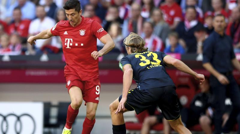 Bundesliga top scorer Robert Lewandowski scored twice to equal a 51-year-old record as champions Bayern Munich demolished Cologne 4-0 on Saturday to climb to the top spot of the standings. (Photo:AFP)