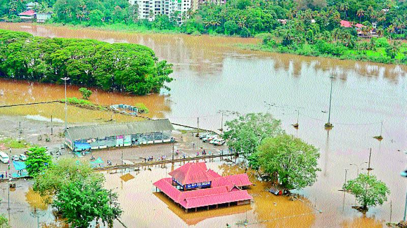 An aerial view of Aluva town following a flash flood, in Kochi on Sunday. 	Coast guard.