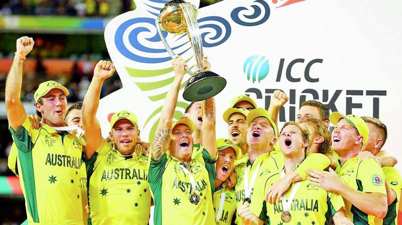 Michael Clarke lifts the World Cup as Australians celebrate.