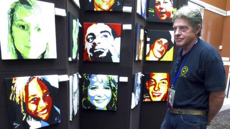 In this Thursday, Aug. 10, 2017 photo, Joe Fitzpatrick looks at a portrait of his daughter, Molly, who died of a drug overdose in 2015, as he attends a reception for artist Anne Marie Zanfagna at the New Hampshire State Library in Concord, N.H. (Photo: AP)
