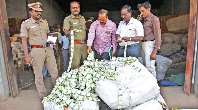 Food safety officers along with cops inspect gutka seized from godown in Royapuram on Friday. (Photo: DC)
