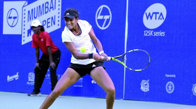 Rutuja Bhosale hits a shot during her match at the Mumbai Open at the CCI courts on Tuesday.