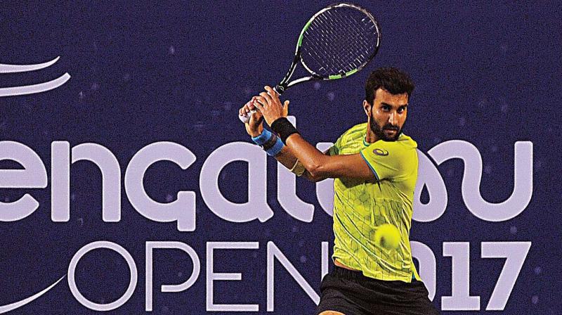 Yuki Bhambri plays a return to N. Sriram Balaji in the opening round of the ATP Bengaluru Open, at the KSLTA Stadium in Bengaluru on Tuesday. (Photo: SHASHIDHAR B.)