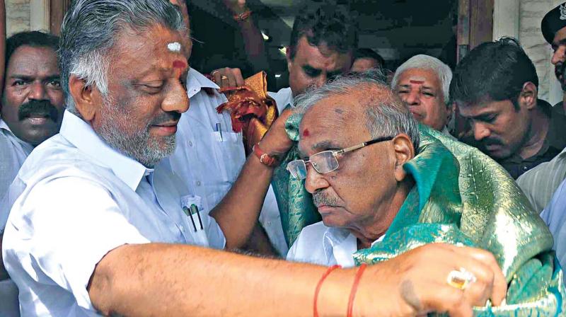 Deputy Chief Minister O. Panneerselvam greets  party veteran E. Madhusudhanan in Chennai on Thursday. (Photo: DC)
