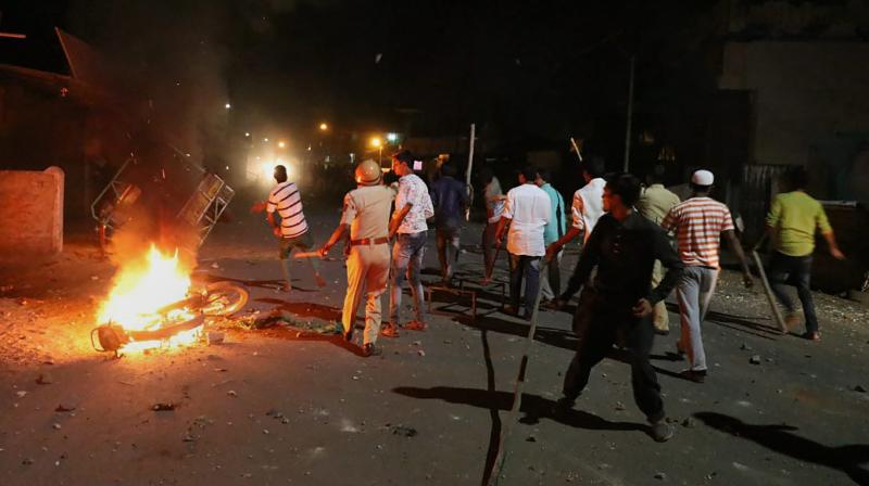 Rioters hurl stones and sticks during a communal riot that escalated due to clamping illegal water connection in a religious place in Moti Karanja area of Aurangabad on Friday night. (Photo: PTI)