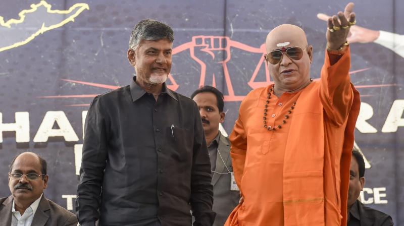 Chief Minister Chandrababu Naidu, left, and a NTR lookalike during Dharma Porata Deeksha, a day-long fast to demand special status for the state of Andhra Pradesh, in New Delhi, Monday. (Photo: AP)