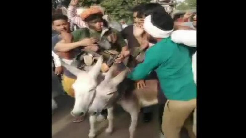 Watch: BSP leaders\ face blackened, paraded on donkeys; Mayawati blames Cong