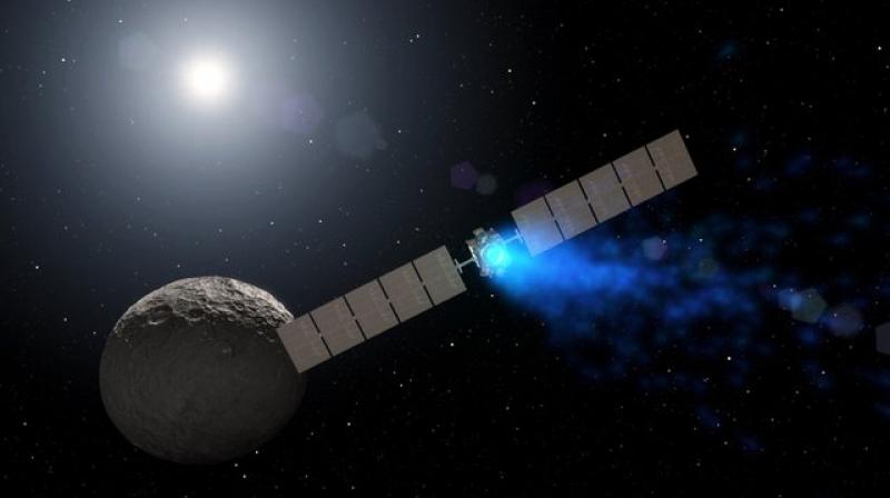 This illustration made available by NASA depicts the Dawn spacecraft orbiting the dwarf planet Ceres. On Thursday, Nov. 1, 2018, NASA announced it had lost the probe, ending a fruitful mission in the asteroid belt. (NASA via AP)
