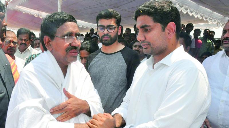Telugu Desam national general-secretary and AP minister Nara Lokesh consoles minister and father of Nishit, who died in a road accident along with his friend Kamani Raja Ravichandra, in Nellore on Thursday.