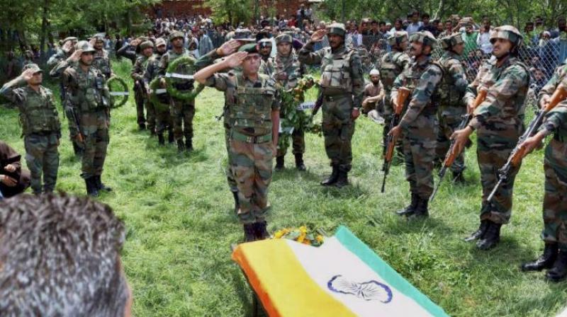 Army personnel paying tribute to the slain army officer Lt. Ummer Fayyaz during his funeral at his native village Sudsona in Kulgam district. (Photo: PTI)