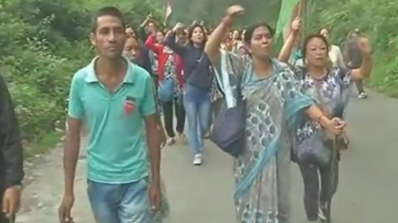 Naari Morcha of GJM protests against the raid at residence of GJM Assistant Gen Secy Binay Tamang. (Photo: ANI Twitter)